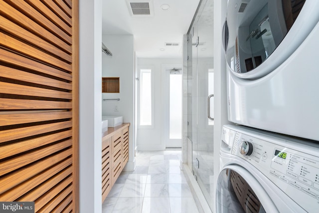 1830 Rittenhouse Sq Unit 17B, Philadelphia, PA 19103 - laundry area featuring visible vents, laundry area, marble finish floor, and stacked washer / drying machine