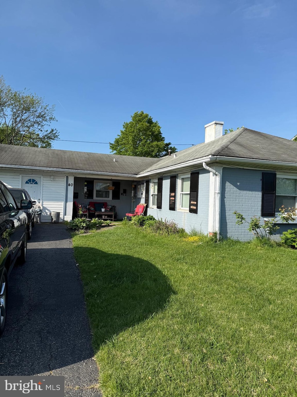 40 Madestone Ln, Willingboro, NJ 08046 - ranch-style house featuring brick siding, a chimney, a front yard, and aphalt driveway