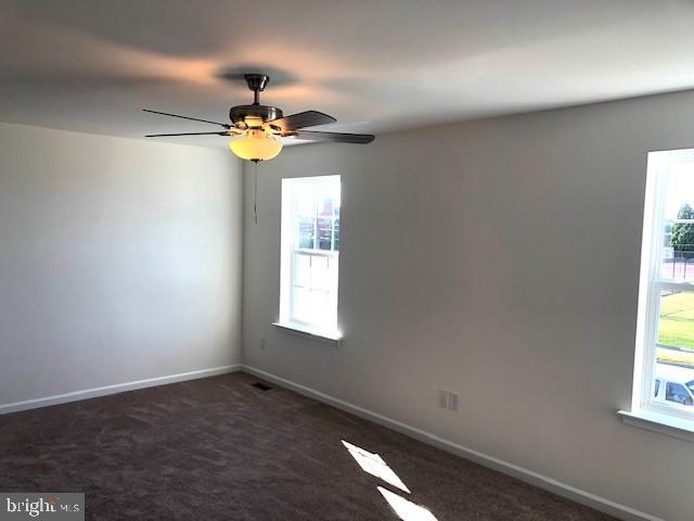 308 Nowland Ln, Delaware City, DE 19706 - spare room with a ceiling fan, baseboards, and carpet