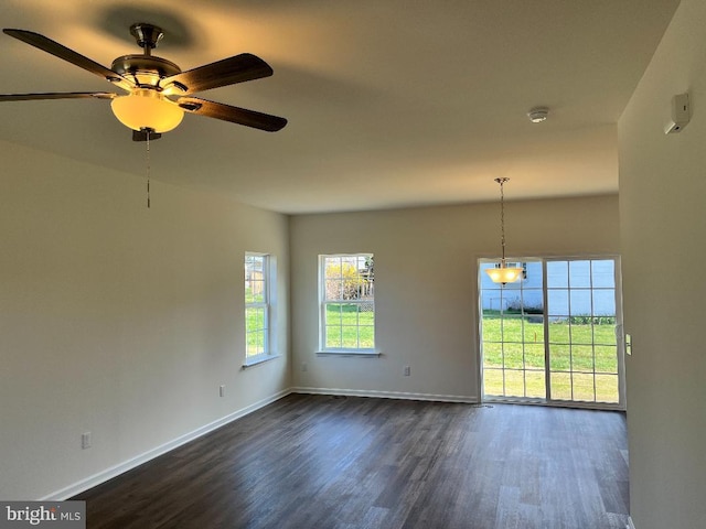 308 Nowland Ln, Delaware City, DE 19706 - empty room with a ceiling fan, dark wood-style floors, and baseboards