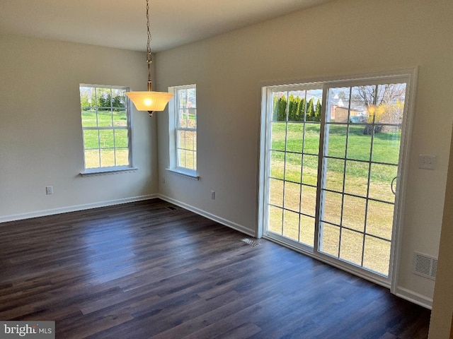 308 Nowland Ln, Delaware City, DE 19706 - unfurnished dining area with dark wood-type flooring, visible vents, and baseboards