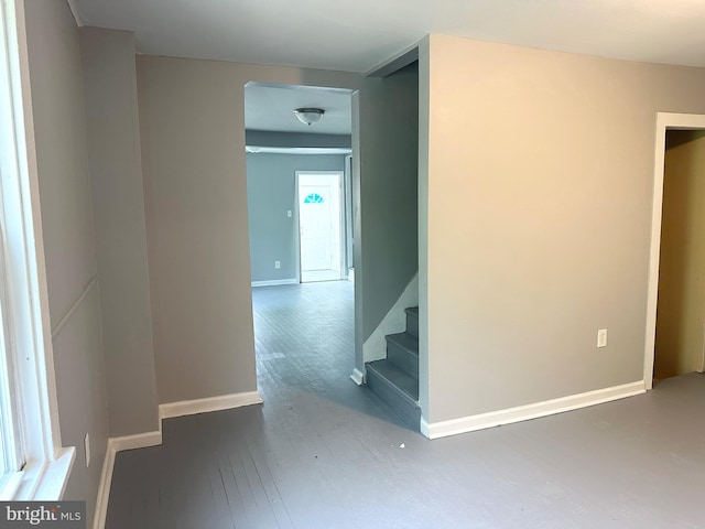 interior space with baseboards, stairs, and hardwood / wood-style floors