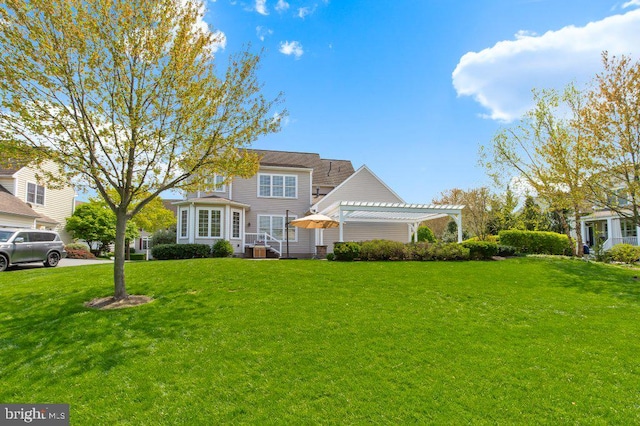 view of front of property with a pergola and a front yard