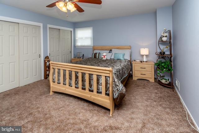 bedroom featuring ceiling fan, multiple closets, and carpet