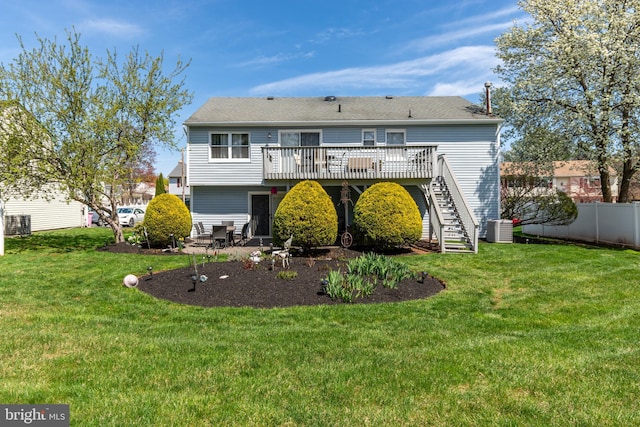 back of property with a yard, cooling unit, stairs, a deck, and fence