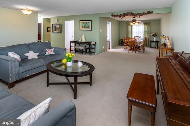 living area with carpet and ceiling fan