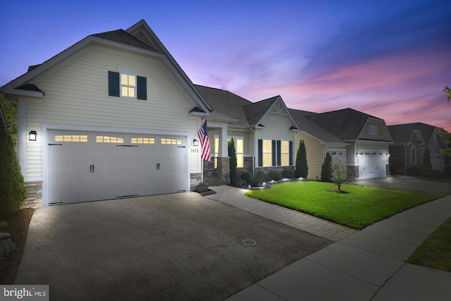 3058 Sunny Ridge Dr, Odenton, MD 21113 - view of front of house featuring stone siding, asphalt driveway, a yard, and a garage