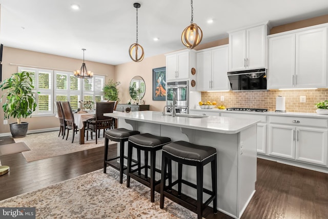 3058 Sunny Ridge Dr, Odenton, MD 21113 - kitchen with a sink, gas stovetop, light countertops, dark wood finished floors, and tasteful backsplash
