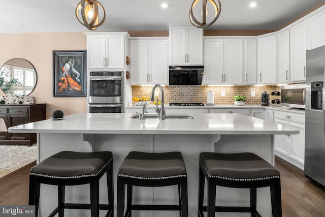 3058 Sunny Ridge Dr, Odenton, MD 21113 - kitchen with a sink, appliances with stainless steel finishes, white cabinetry, decorative backsplash, and recessed lighting