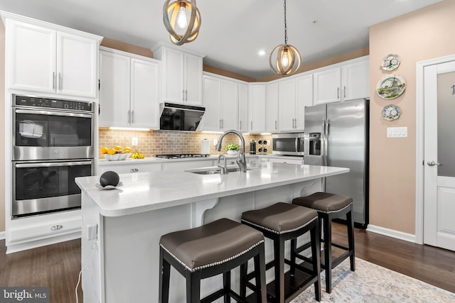 3058 Sunny Ridge Dr, Odenton, MD 21113 - kitchen with appliances with stainless steel finishes, a sink, white cabinets, backsplash, and dark wood-style floors