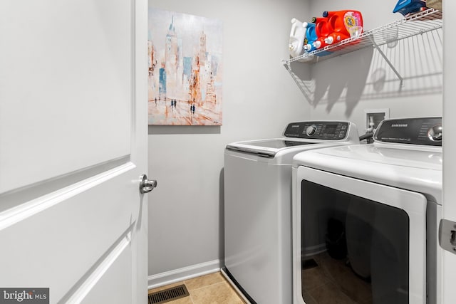 3058 Sunny Ridge Dr, Odenton, MD 21113 - laundry room featuring washer and dryer, baseboards, and light tile patterned floors