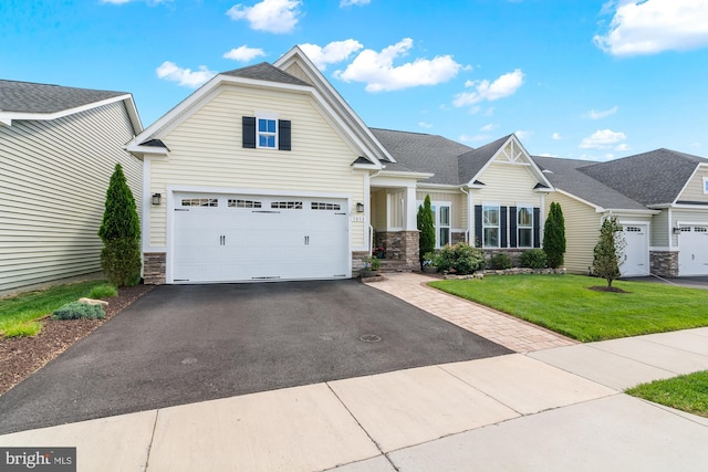 3058 Sunny Ridge Dr, Odenton, MD 21113 - view of front facade with stone siding, asphalt driveway, a front lawn, and a garage
