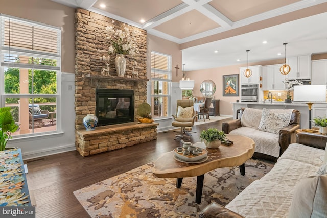 3058 Sunny Ridge Dr, Odenton, MD 21113 - living room featuring healthy amount of natural light, dark wood-type flooring, a fireplace, recessed lighting, and beamed ceiling