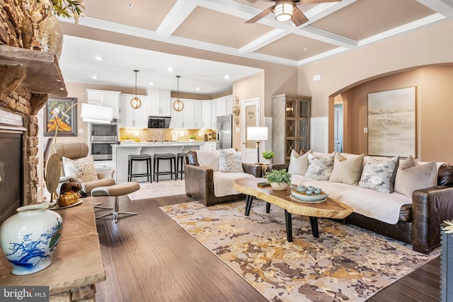 3058 Sunny Ridge Dr, Odenton, MD 21113 - living area with arched walkways, light wood finished floors, ceiling fan, coffered ceiling, and beam ceiling