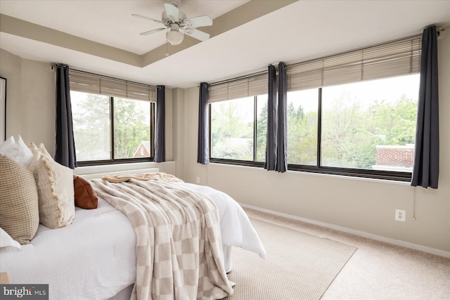 carpeted bedroom with baseboards and a ceiling fan