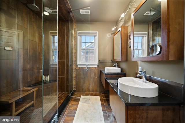 full bath featuring tile walls, a sink, and a wealth of natural light