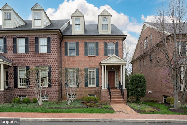view of property featuring brick siding