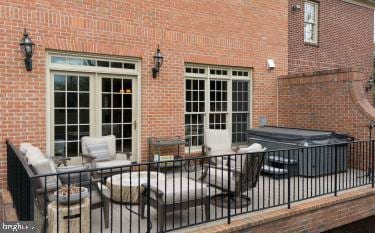 view of patio / terrace with french doors and a hot tub