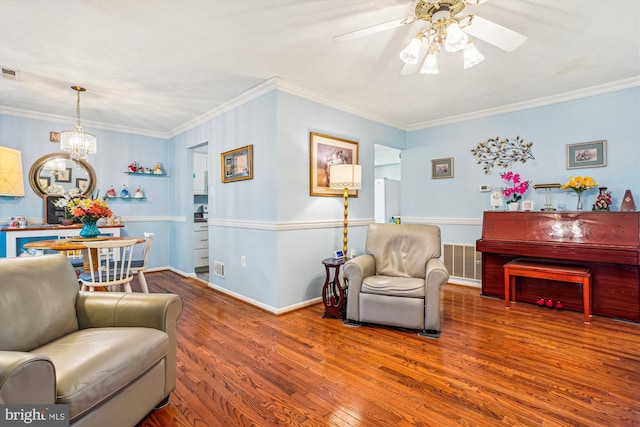 10114 Erin Ct, Manassas, VA 20110 - living room featuring crown molding, ceiling fan with notable chandelier, wood finished floors, and visible vents