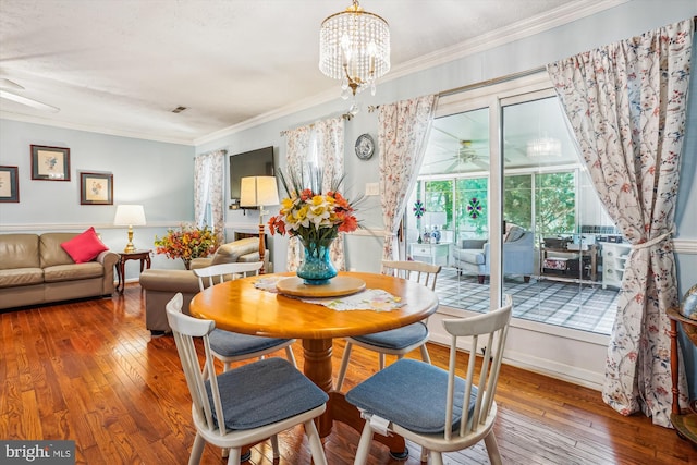 10114 Erin Ct, Manassas, VA 20110 - dining room featuring hardwood / wood-style flooring, ornamental molding, and ceiling fan with notable chandelier