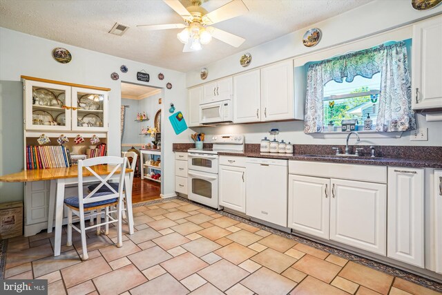 10114 Erin Ct, Manassas, VA 20110 - kitchen with visible vents, a sink, white cabinets, and white appliances