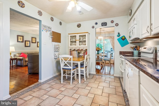 10114 Erin Ct, Manassas, VA 20110 - dining space featuring baseboards, a ceiling fan, and a textured ceiling