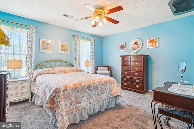 10114 Erin Ct, Manassas, VA 20110 - carpeted bedroom with a textured ceiling, visible vents, and ceiling fan