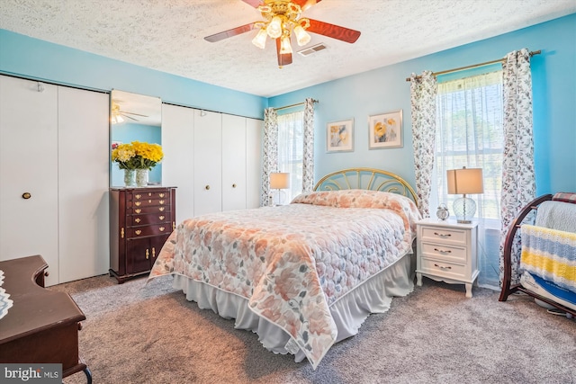10114 Erin Ct, Manassas, VA 20110 - carpeted bedroom with a textured ceiling, multiple closets, ceiling fan, and visible vents