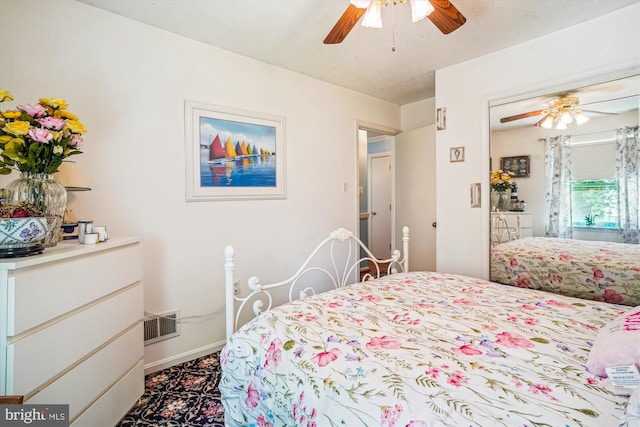 10114 Erin Ct, Manassas, VA 20110 - bedroom featuring baseboards, a ceiling fan, dark colored carpet, and visible vents