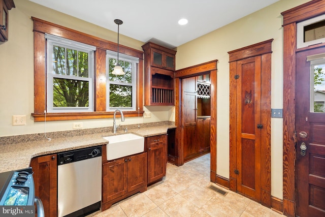 kitchen with visible vents, pendant lighting, stainless steel dishwasher, a sink, and light stone counters