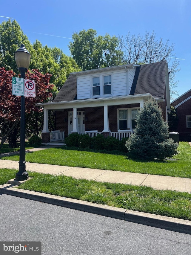 bungalow-style home with a porch and a front yard