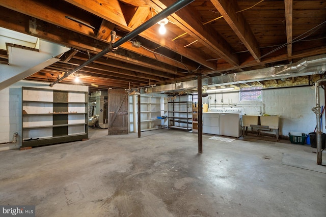 unfinished below grade area with washing machine and clothes dryer