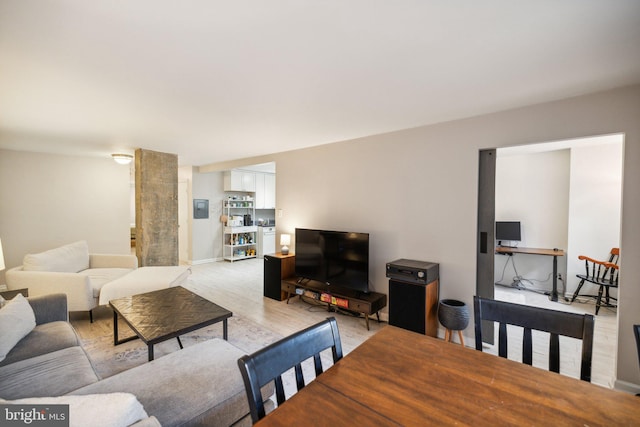 living room featuring baseboards and light wood-style floors