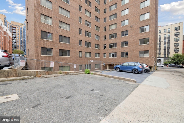 view of building exterior featuring uncovered parking