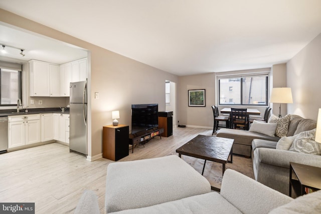 living area with light wood finished floors and baseboards