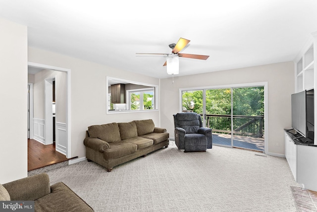 living room with ceiling fan and carpet flooring