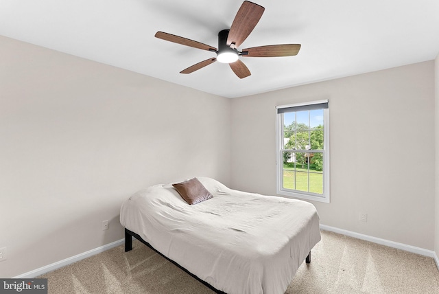 bedroom with baseboards, light colored carpet, and a ceiling fan