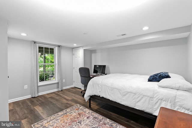 bedroom with wood finished floors, baseboards, and recessed lighting