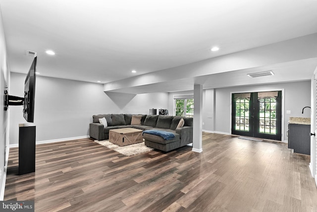 living area with dark wood-style flooring, baseboards, recessed lighting, and french doors