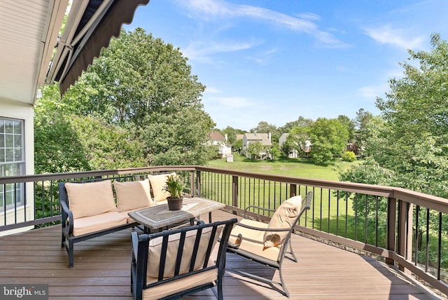 deck featuring an outdoor living space and a yard