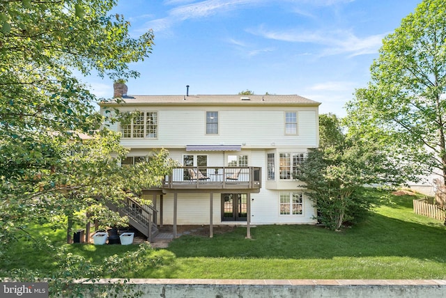 back of house with a chimney, a wooden deck, a lawn, and stairs