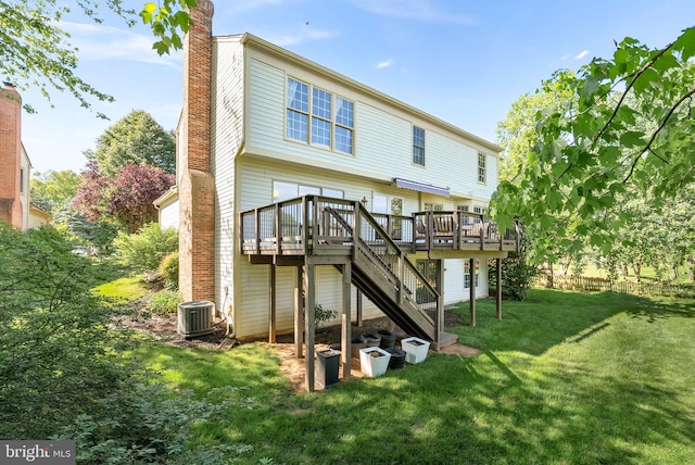 back of house featuring a deck, stairway, a lawn, a chimney, and central AC