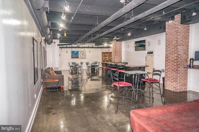 dining area with baseboards and finished concrete floors