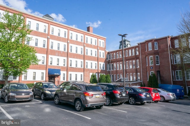 view of building exterior with uncovered parking