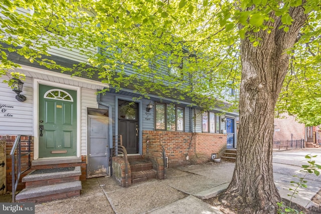 view of front of house featuring entry steps and brick siding