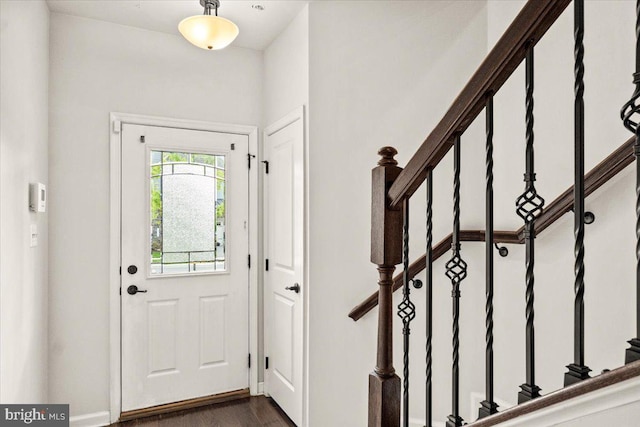 entrance foyer featuring dark wood-style flooring and stairway
