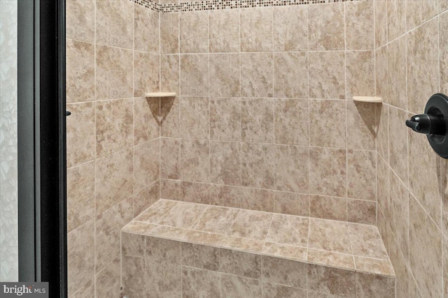 interior details with a tile shower