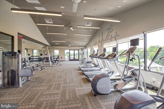 gym featuring high vaulted ceiling, carpet floors, and visible vents