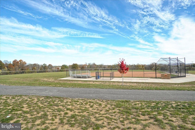view of play area with fence and a tennis court