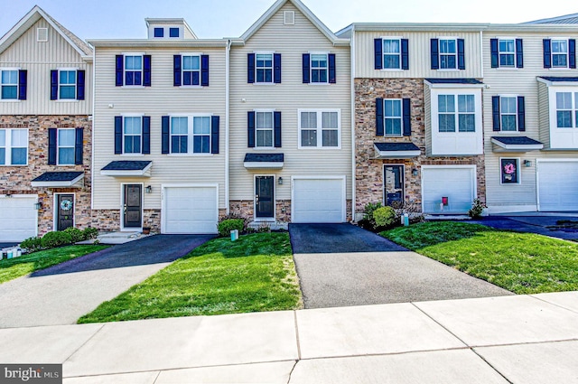 multi unit property featuring driveway, a garage, board and batten siding, and stone siding